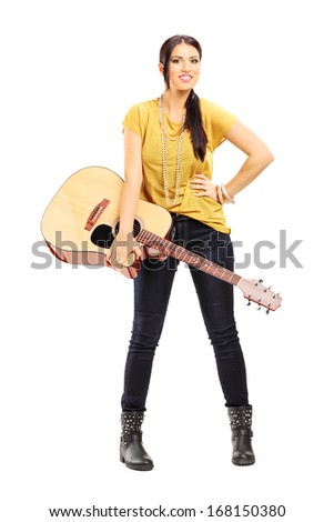 Full length portrait of a female musician holding an acoustic guitar isolated on white background