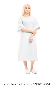 Full Length Portrait Of A Female Patient Posing In A Hospital Gown, Isolated On White Background