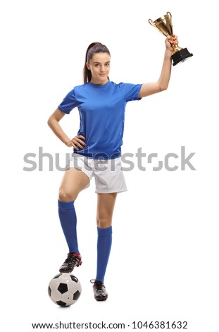 Full length portrait of a female soccer player with a football and a golden trophy isolated on white background