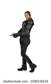 full length portrait of female wearing black  tactical armour, standing pose holding gun, isolated on white studio background.