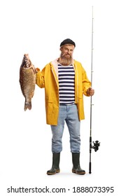 Full length portrait of a fisherman holding a fishing rod and a carp fish isolated on white background