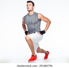 Full Length Portrait Of A Fitness Man Stretching Isolated On A White Background