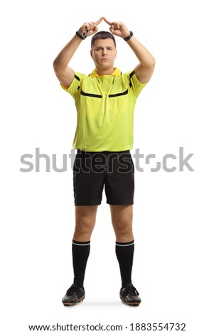 Full length portrait of football referee gesturing a VAR symbol isolated on white background Imagine de stoc © 