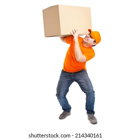 Full Length Portrait Of A Funny Deliverer Lifting An Heavy Box. Isolated On White