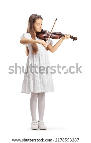 Full length portrait of a girl in a white dress playing a violin isolated on white background 