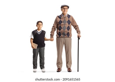 Full length portrait of a grandfather and grandson in a school uniform standing and holding hands isolated on white background - Powered by Shutterstock