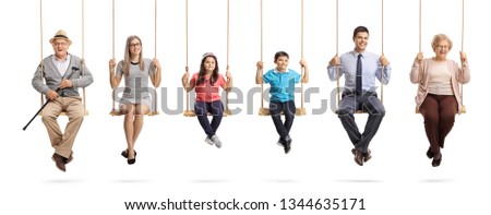 Full length portrait of grandparents, parents and children sitting on swings and smiling at the camera isolated on white background