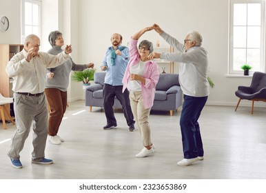 Full length portrait of a group of happy smiling senior people men and women having fun and dancing enjoying activities in retirement home together. Leisure time in nursing home concept. - Powered by Shutterstock