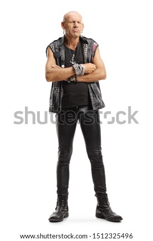 Full length portrait of a grumpy punker standing with arms crossed isolated on white background