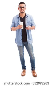 Full Length Portrait Of A Handsome Hipster Man Drinking Coffee And Using A Smartphone On A White Background