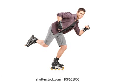 Full Length Portrait Of A Handsome Man Roller Skating Isolated On White Background