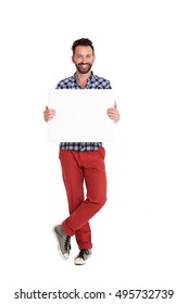 Full Length Portrait Of Handsome Man Holding Blank Poster Over White Background