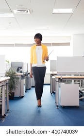 Full Length Portrait Of A Happy Afro American Woman Walking In Office