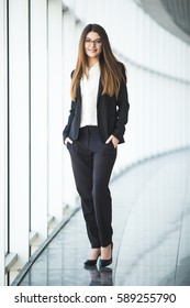 Full Length Portrait Of Happy Business Woman In Office