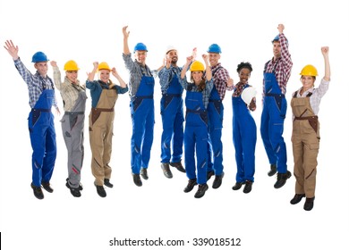 Full length portrait of happy carpenters standing with arms raised against white background