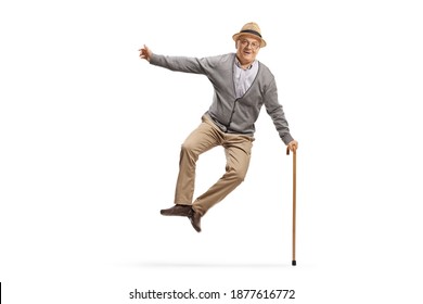 Full length portrait of a happy elderly man jumping isolated on white background