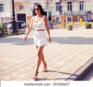 Full Length Portrait Of A Happy Fashion Woman Walking In Town