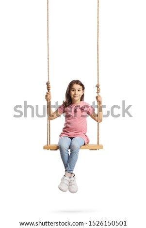 Full length portrait of a happy little girl sitting on a wooden swing isolated on white background