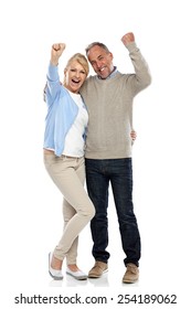 Full Length Portrait Of Happy Mature Couple Cheering On White Background