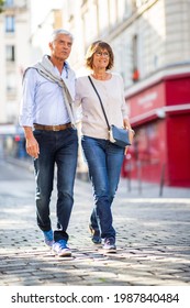 Full Length Portrait Happy Older Couple Walking On Street Together