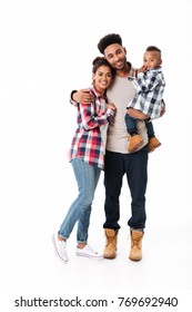 Full Length Portrait Of A Happy Young African Family With Their Little Son Standing Together Isolated Over White Background