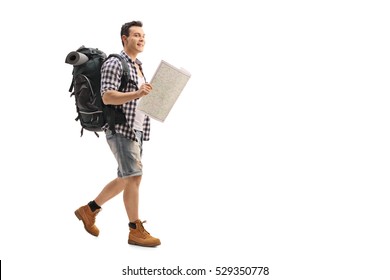 Full Length Portrait Of A Hiker Walking And Holding A Generic Map Isolated On White Background