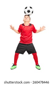 Full Length Portrait Of A Junior Soccer Player Joggling With A Ball Isolated On White Background