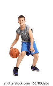 Full length portrait of a kid playing with a basketball isolated on white background