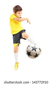 Full Length Portrait Of A Kid In Sportswear Shooting A Soccer Ball Isolated On White Background