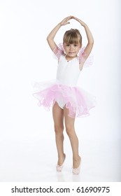 Full length portrait of a little ballerina trying a new ballet position, studio image