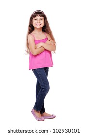 Full Length Portrait Of A Little Girl Standing With Folded Hands Over White Background