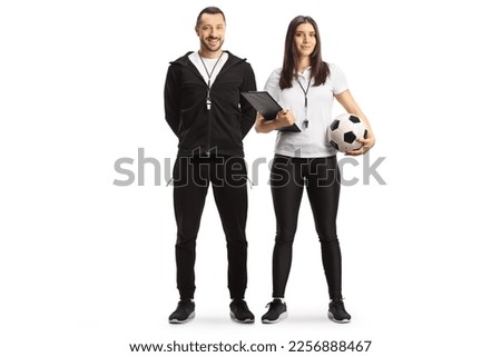 Full length portrait of a male and female football coaches posing isolated on white background

