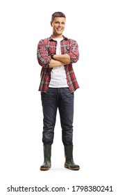 Full length portrait of a male gardener in boots posing with crossed arms isolated on a white background
