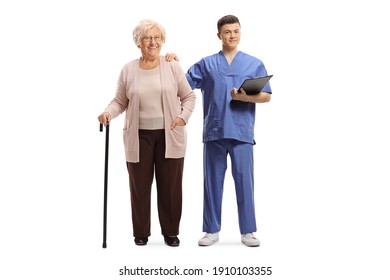 Full Length Portrait Of A Male Nurse With A Clipboard And An Elderly Female Patient With A Walking Cane Isolated On White Background