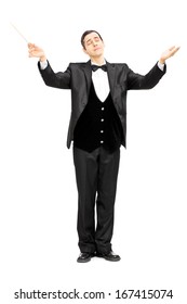 Full Length Portrait Of A Male Orchestra Conductor Directing With Baton Isolated On White Background