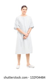 Full Length Portrait Of A Male Patient In A Hospital Gown, Isolated On White Background