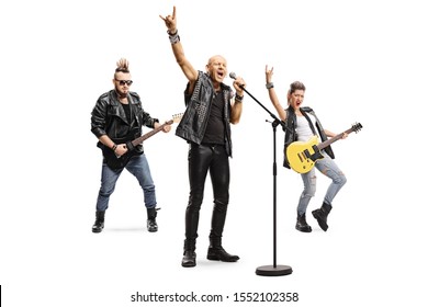 Full length portrait of a male rock star singing on a microphone and male and female musicians playing guitars isolated on white background