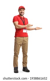 Full Length Portrait Of A Male Shop Assistant Gesturing Welcome Isolated On White Background