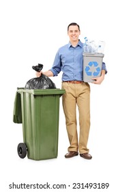 Full Length Portrait Of A Man Holding A Recycle Bin By A Trash Can Isolated On White Background