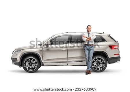 Full length portrait of a man leaning on a SUV isolated on white background