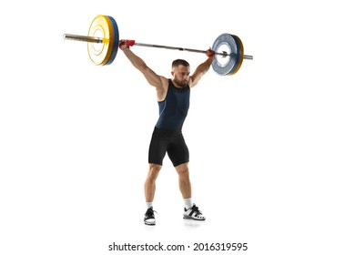 Full length portrait of man in sportswear exercising with a weight isolated on white background. Fit young muscular caucasian model with barbell training at abstract gym. Sport, weightlifting concept - Powered by Shutterstock