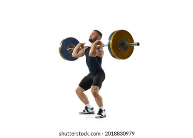 Full length portrait of man in sportswear exercising with a weight isolated on white background. Fit young muscular caucasian model with barbell training at abstract gym. Sport, weightlifting concept