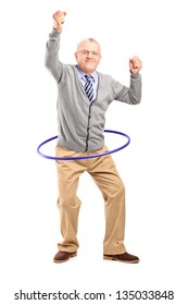 Full length portrait of a mature gentleman dancing with a hula hoop isolated on white background