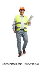 Full length portrait of a mature male engineer holding blueprints and walking towards camera isolated on white background