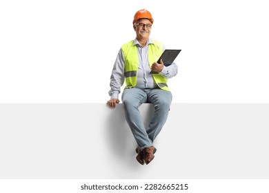 Full length portrait of a mature male engineer sitting ona blank panel and looking at camera isolated on white background - Powered by Shutterstock