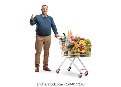 Full length portrait of a mature man with a shopping cart gesturing a thumb up sign isolated on white background - Powered by Shutterstock