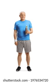 Full length portrait of a mature man in sportswear holding a plastic bottle isolated on white background