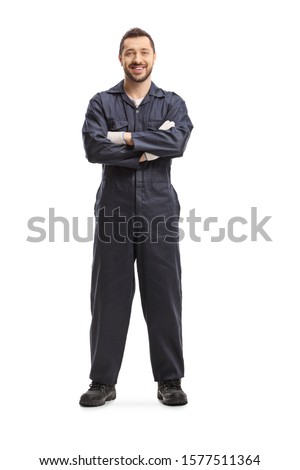Full length portrait of a mechanic in a dark blue overalls isolated on white background