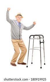 Full length portrait of an old man with a walker raising his hands isolated on white background