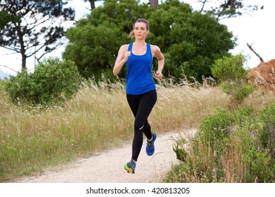 Full Length Portrait Of Older Woman Jogging In Countryside